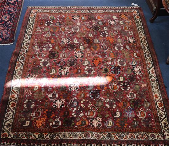 An Iranian red ground carpet with pears, 145 x 117cm